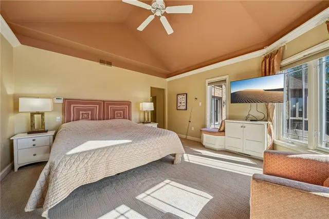 a bedroom with a large bed and a chandelier