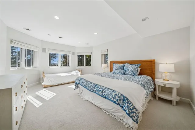 a bedroom with a large bed and dresser