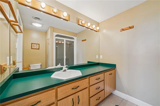 a living room with furniture kitchen view and a large window