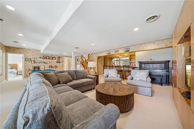 a dining table chairs next to a window