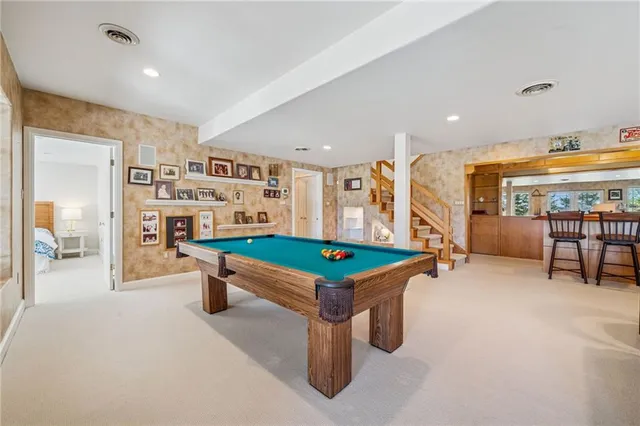a room with furniture and pool table