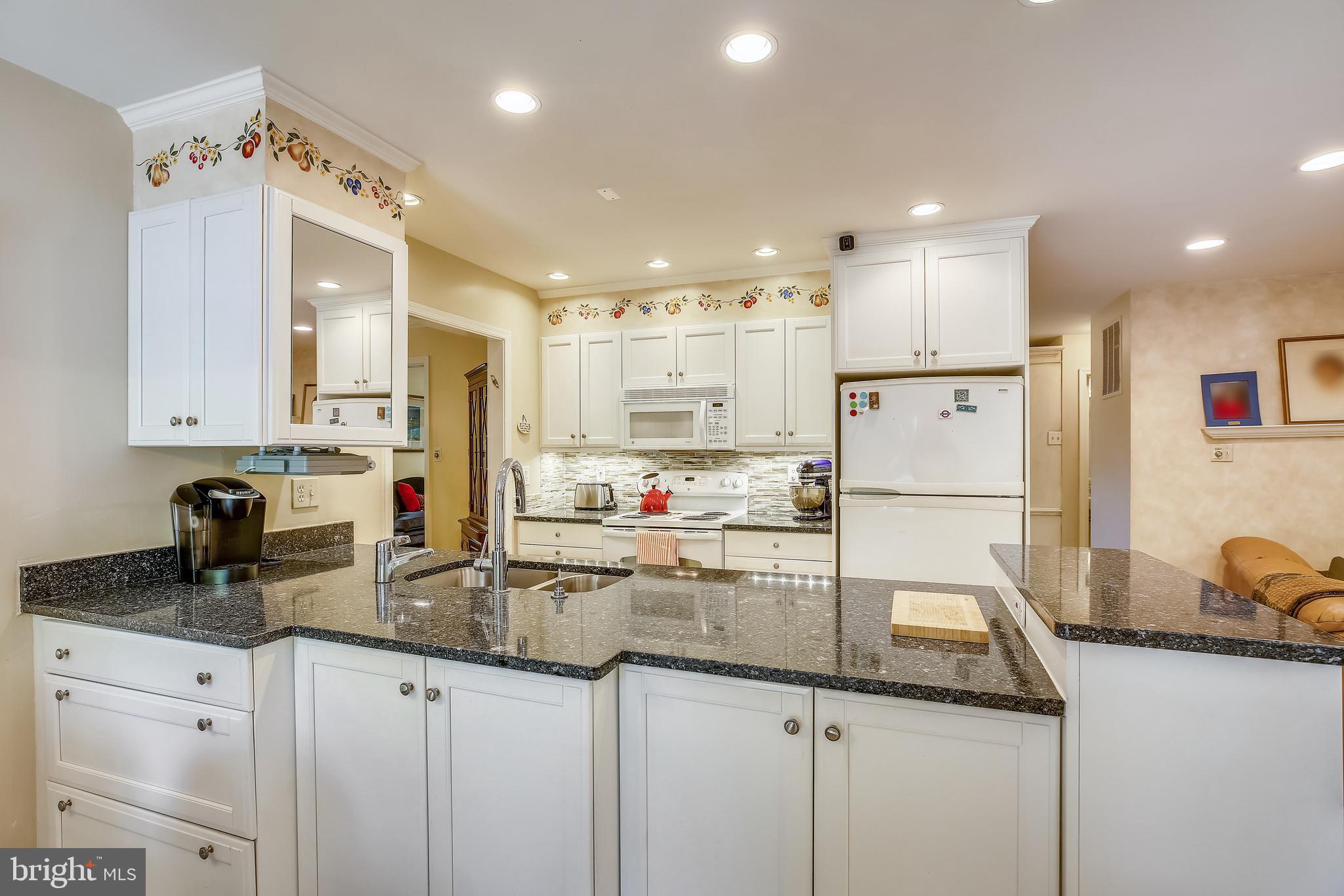 701 Kersey Road Silver Spring, MD 20902 - Photo 22 of 66 Recessed lights, cabinets brighten kitchen.