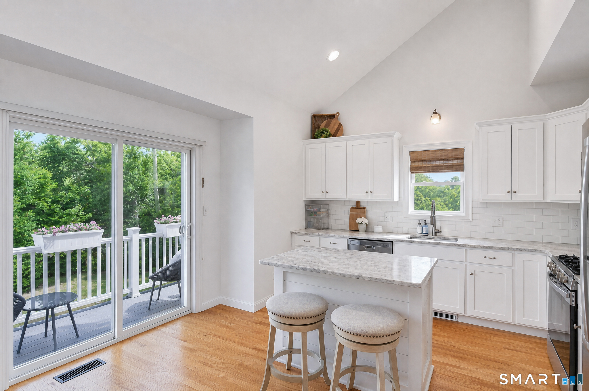 43 George Street, Unit 1 Seymour, CT 06483 - Photo 8 of 33 The light and bright kitchen features a slider to the balcony/deck, center island and hardwood flooring.