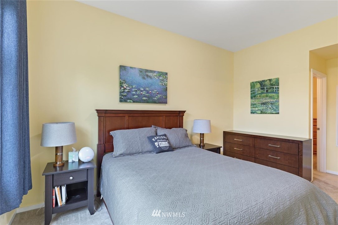 111 164th Place Southeast Bothell, WA 98012 - Photo 17 of 27 a bedroom with a bed and a lamp on dresser