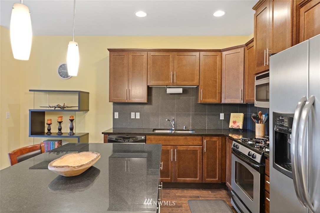 111 164th Place Southeast Bothell, WA 98012 - Photo 7 of 27 a kitchen with stainless steel appliances granite countertop a sink a stove counter space and cabinets
