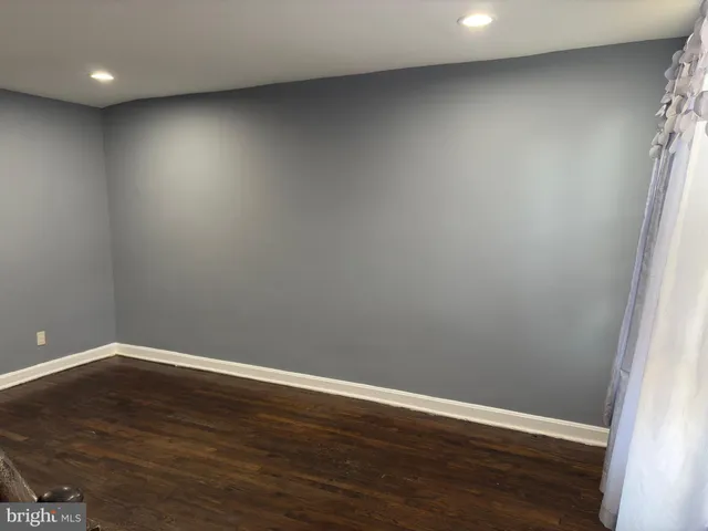 a view of room with wooden floor