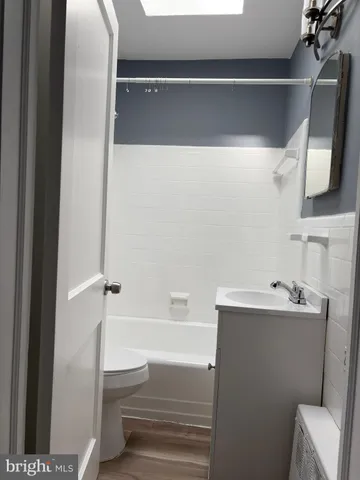 a bathroom with a sink mirror vanity and toilet