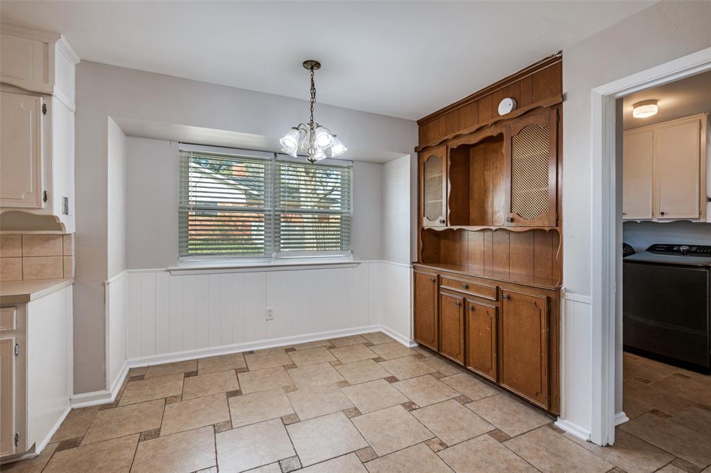 1428 Pamela Street Hurst, TX 76053 - Photo 11 of 25 a kitchen with granite countertop a refrigerator and a sink