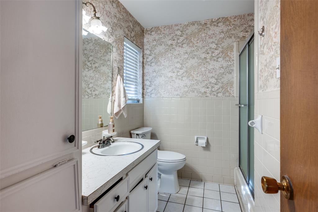 1428 Pamela Street Hurst, TX 76053 - Photo 20 of 25 a bathroom with a sink toilet and shower
