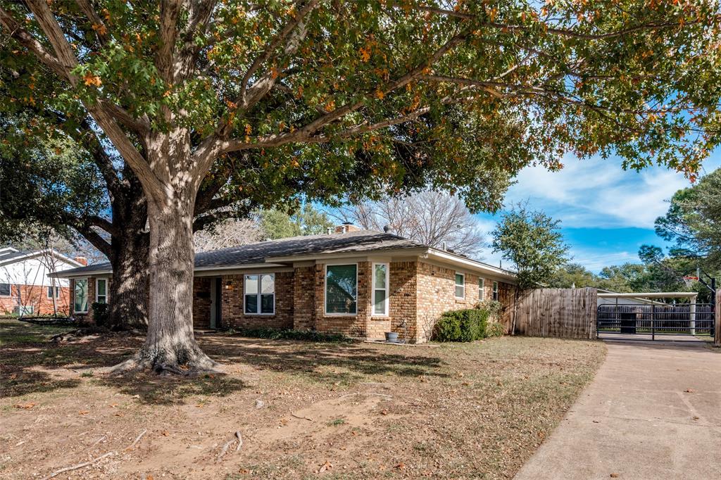 1428 Pamela Street Hurst, TX 76053 - Photo 2 of 25 a front view of a house with a garden