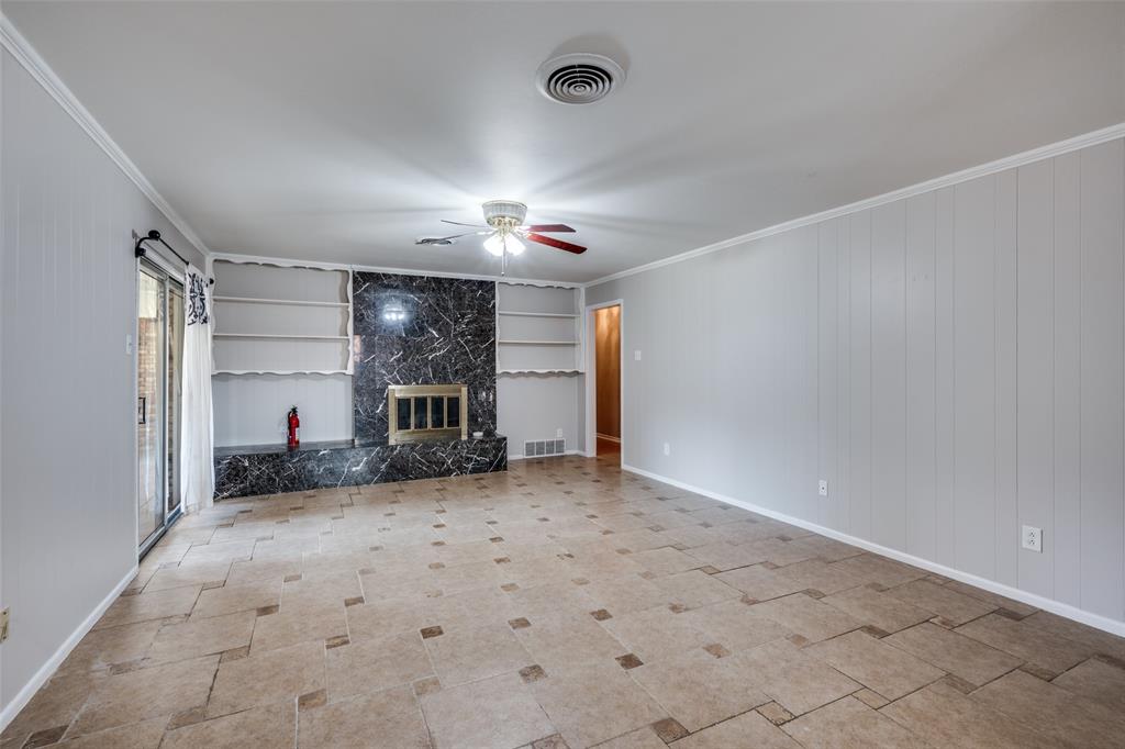 1428 Pamela Street Hurst, TX 76053 - Photo 6 of 25 a view of a livingroom with a fireplace and a window