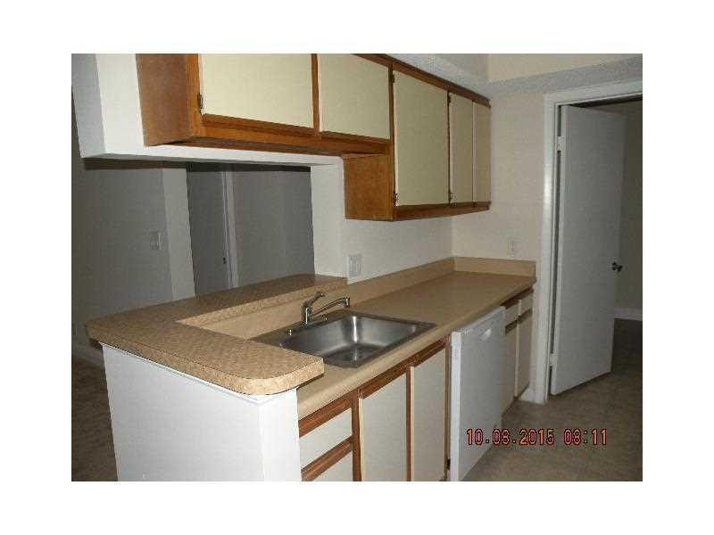 5760 Rock Island Road, Unit 328 Tamarac, FL 33319 - Photo 4 of 16 a kitchen with a sink and cabinets