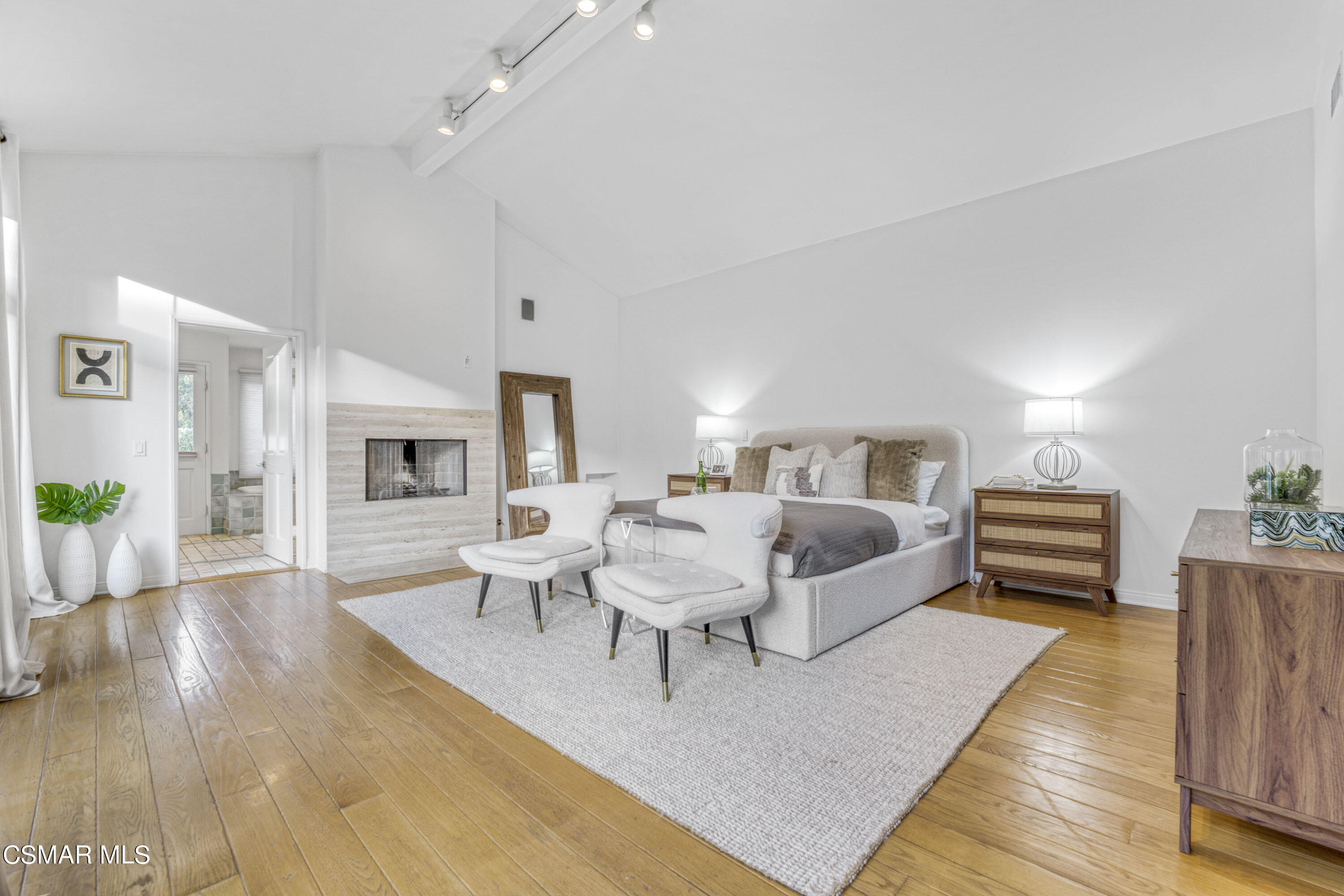 14401 Villa Woods Place Pacific Palisades, CA 90272 - Photo 12 of 46 a spacious bedroom with a bed a couch and a table