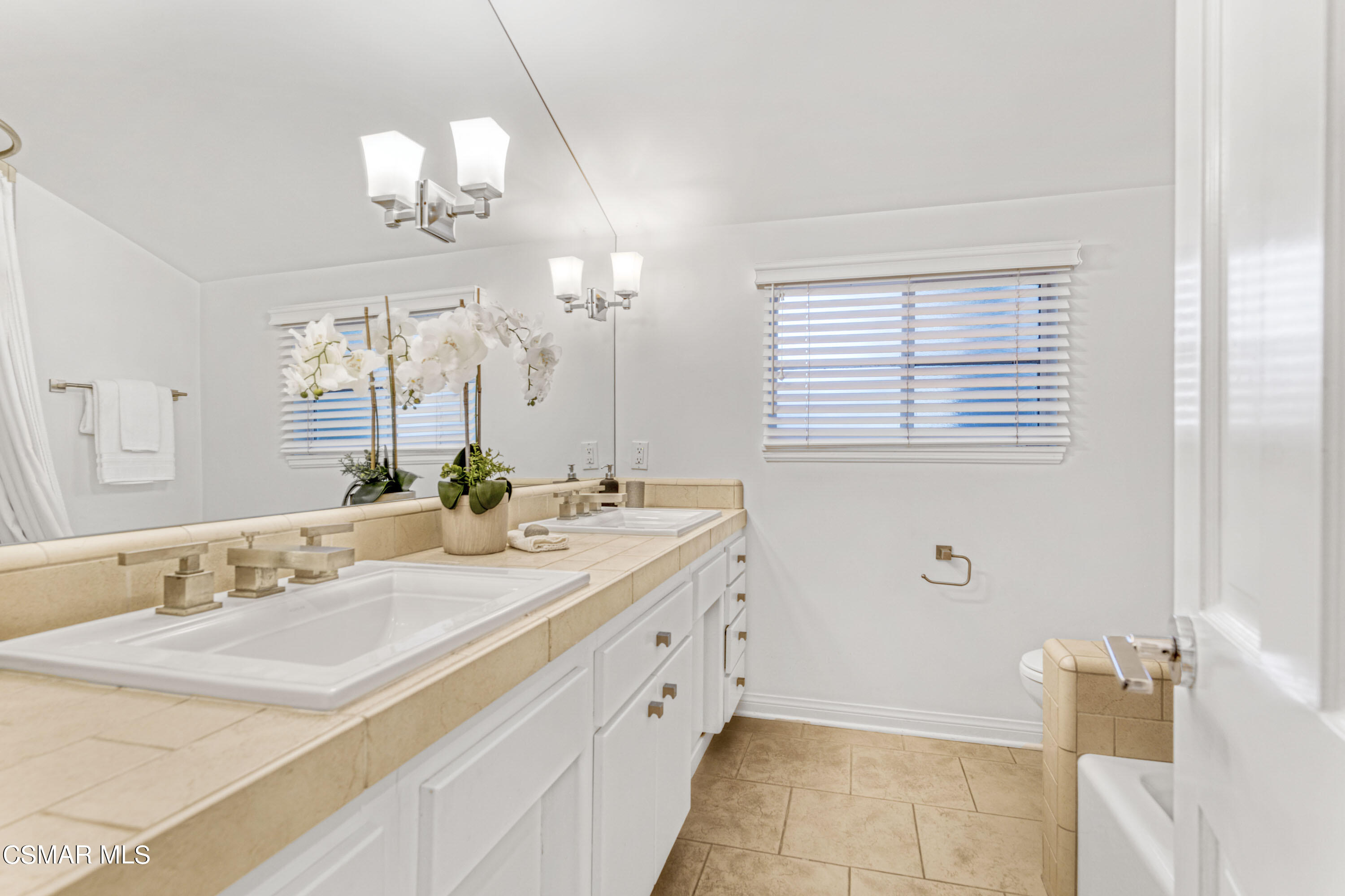 14401 Villa Woods Place Pacific Palisades, CA 90272 - Photo 18 of 46 a bathroom with a sink a vanity and a mirror