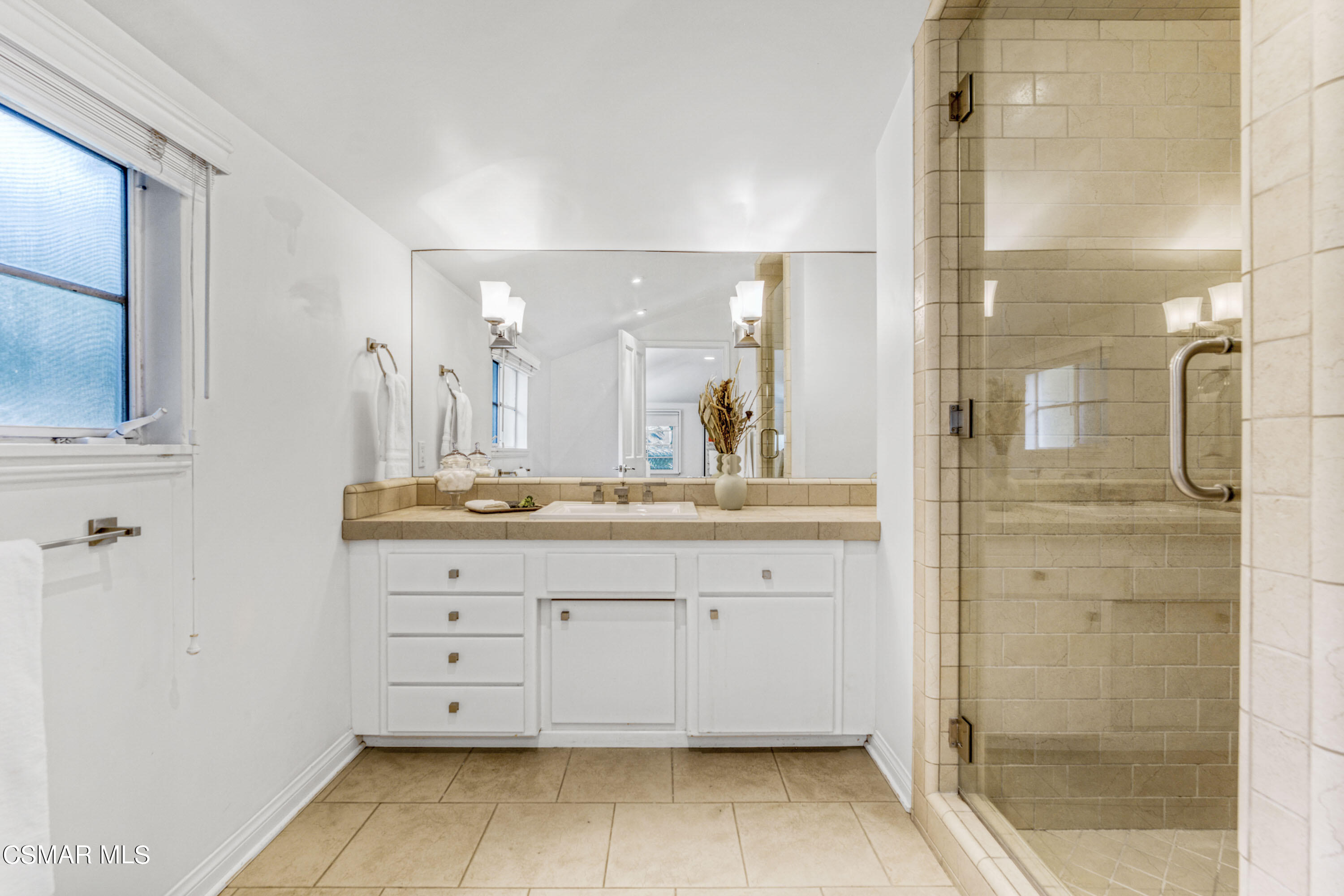 14401 Villa Woods Place Pacific Palisades, CA 90272 - Photo 21 of 46 a bathroom with a double vanity sink a mirror and a shower