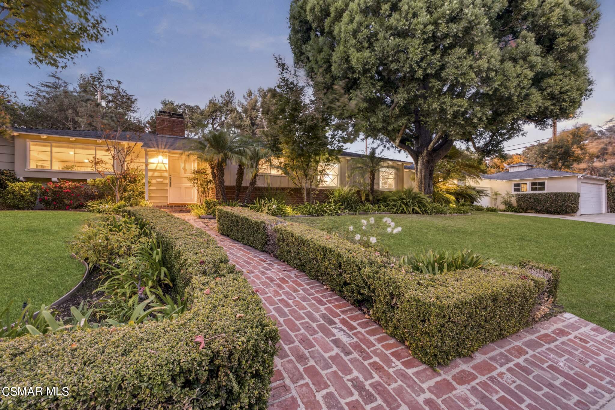 14401 Villa Woods Place Pacific Palisades, CA 90272 - Photo 28 of 46 a front view of a house with a yard