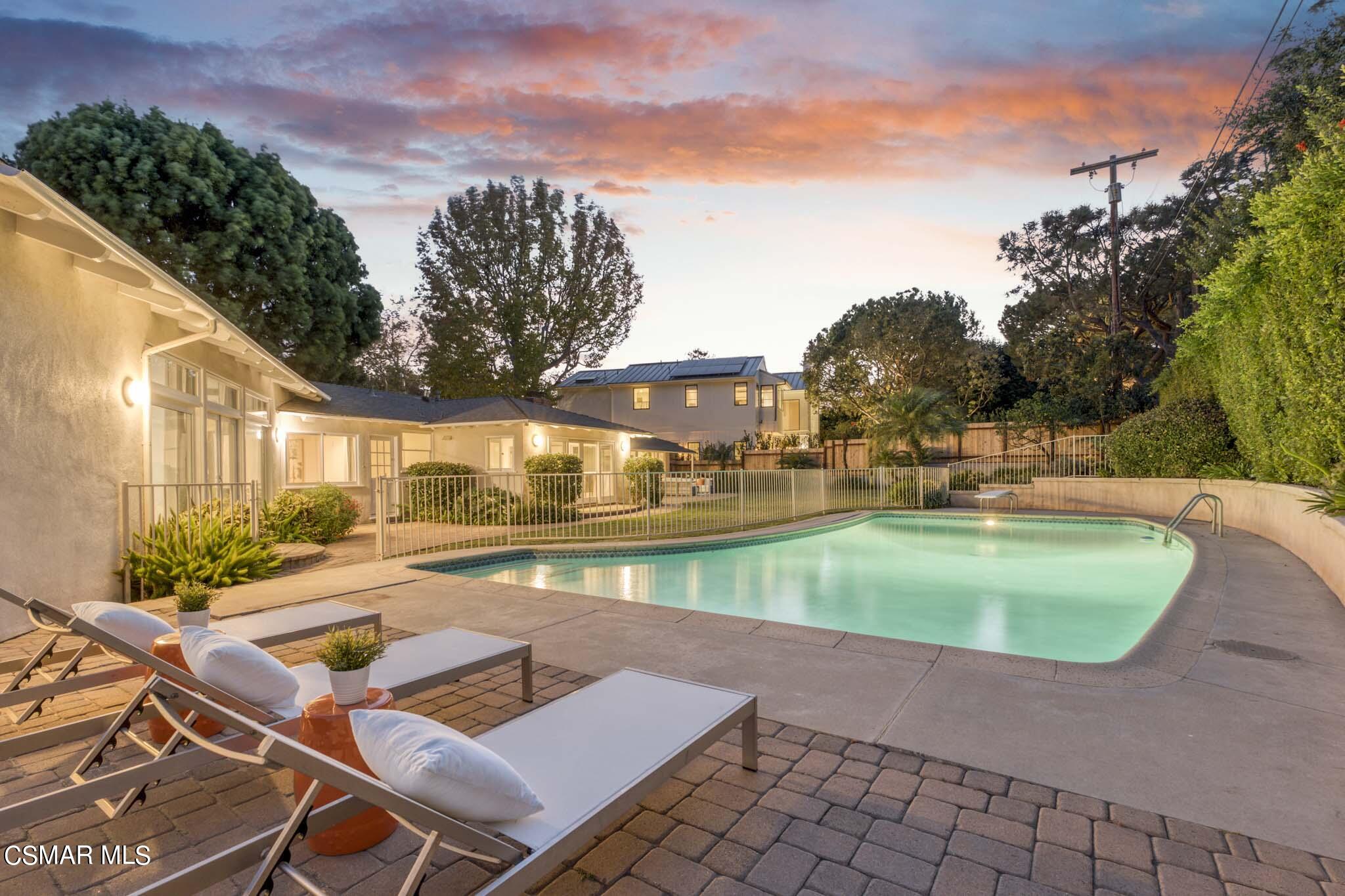 14401 Villa Woods Place Pacific Palisades, CA 90272 - Photo 30 of 46 a view of a swimming pool with a lounge chairs