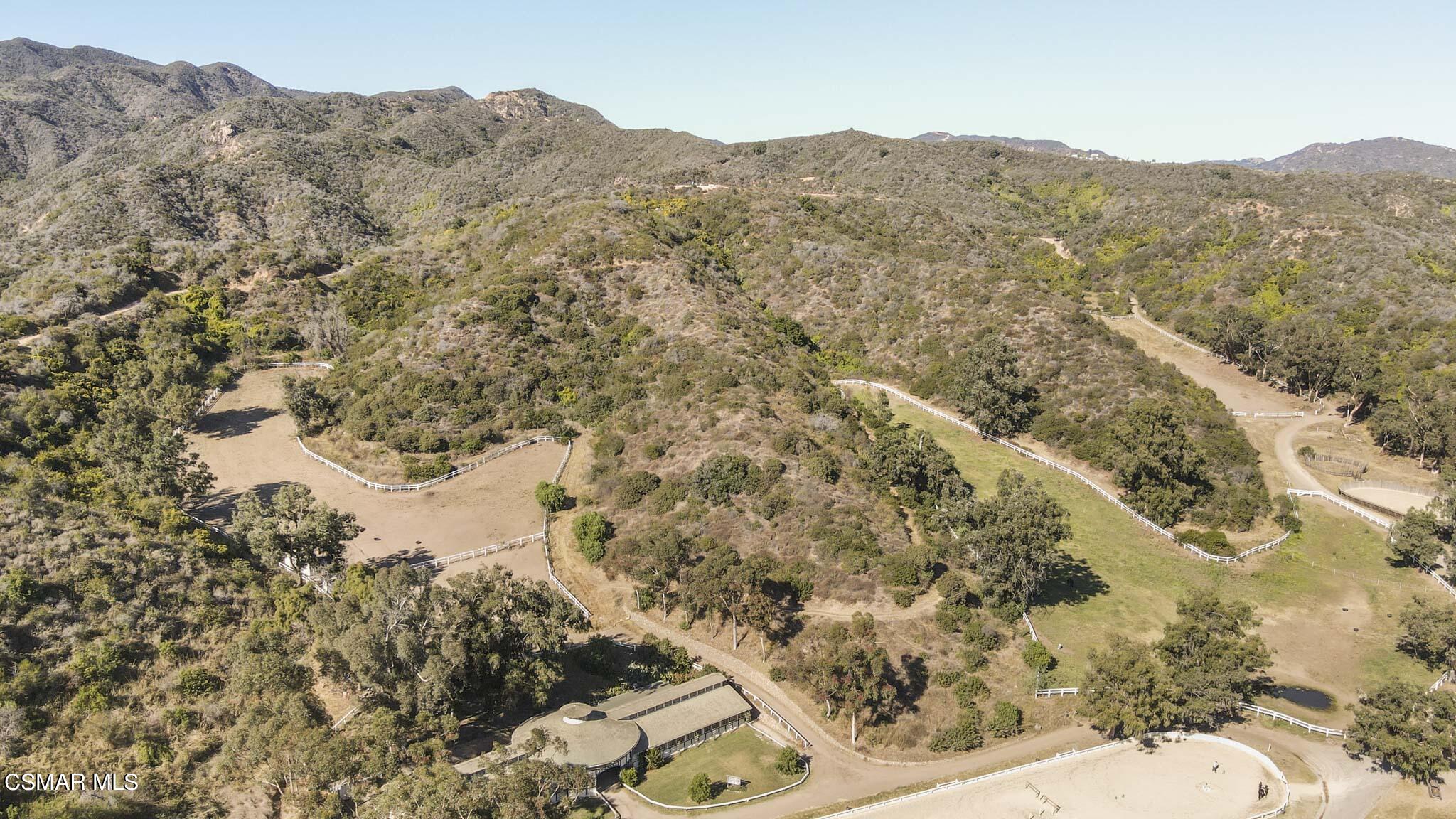 14401 Villa Woods Place Pacific Palisades, CA 90272 - Photo 42 of 46 a view of a dry yard with mountains in the background