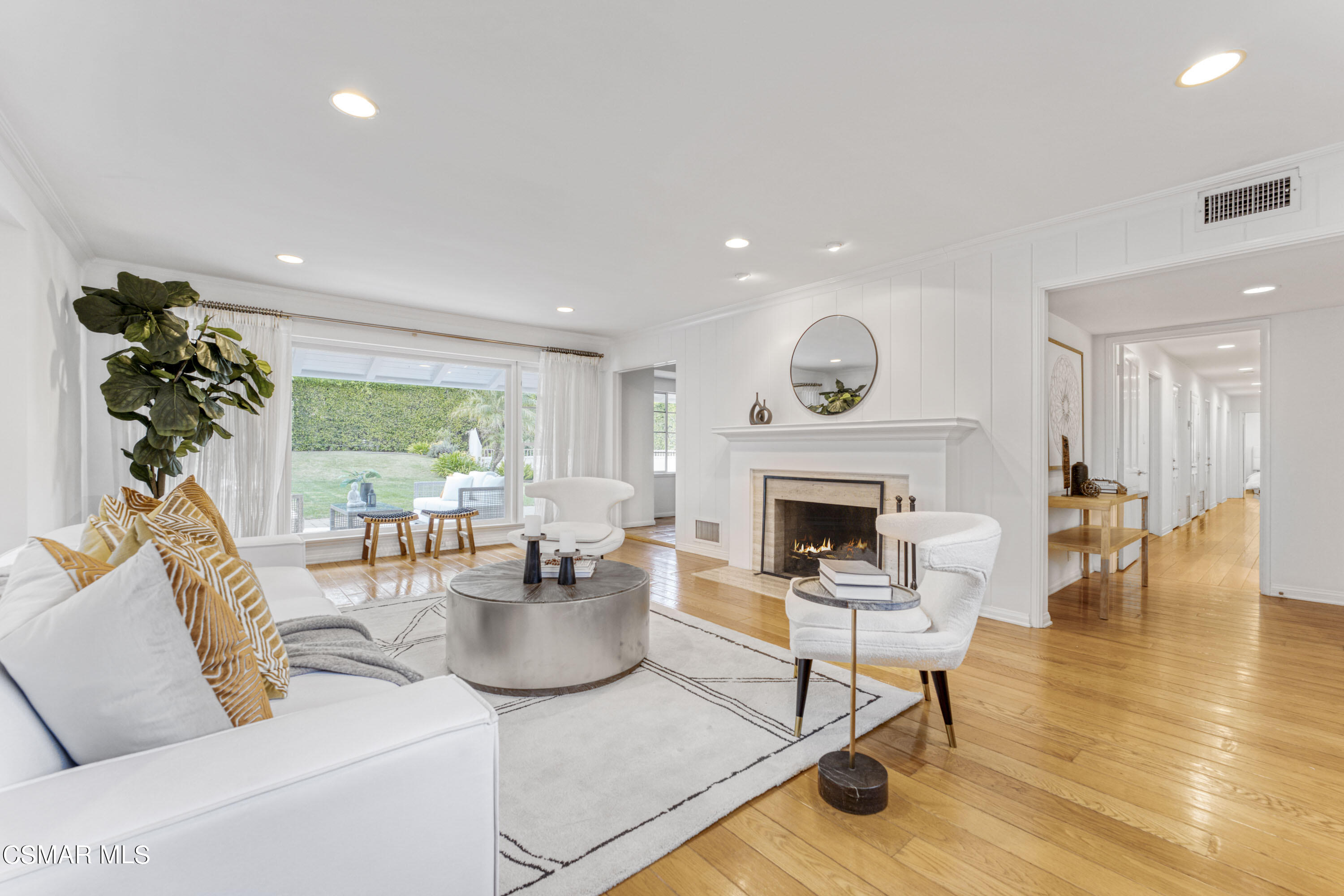 14401 Villa Woods Place Pacific Palisades, CA 90272 - Photo 5 of 46 a living room with furniture a fireplace and a potted plant