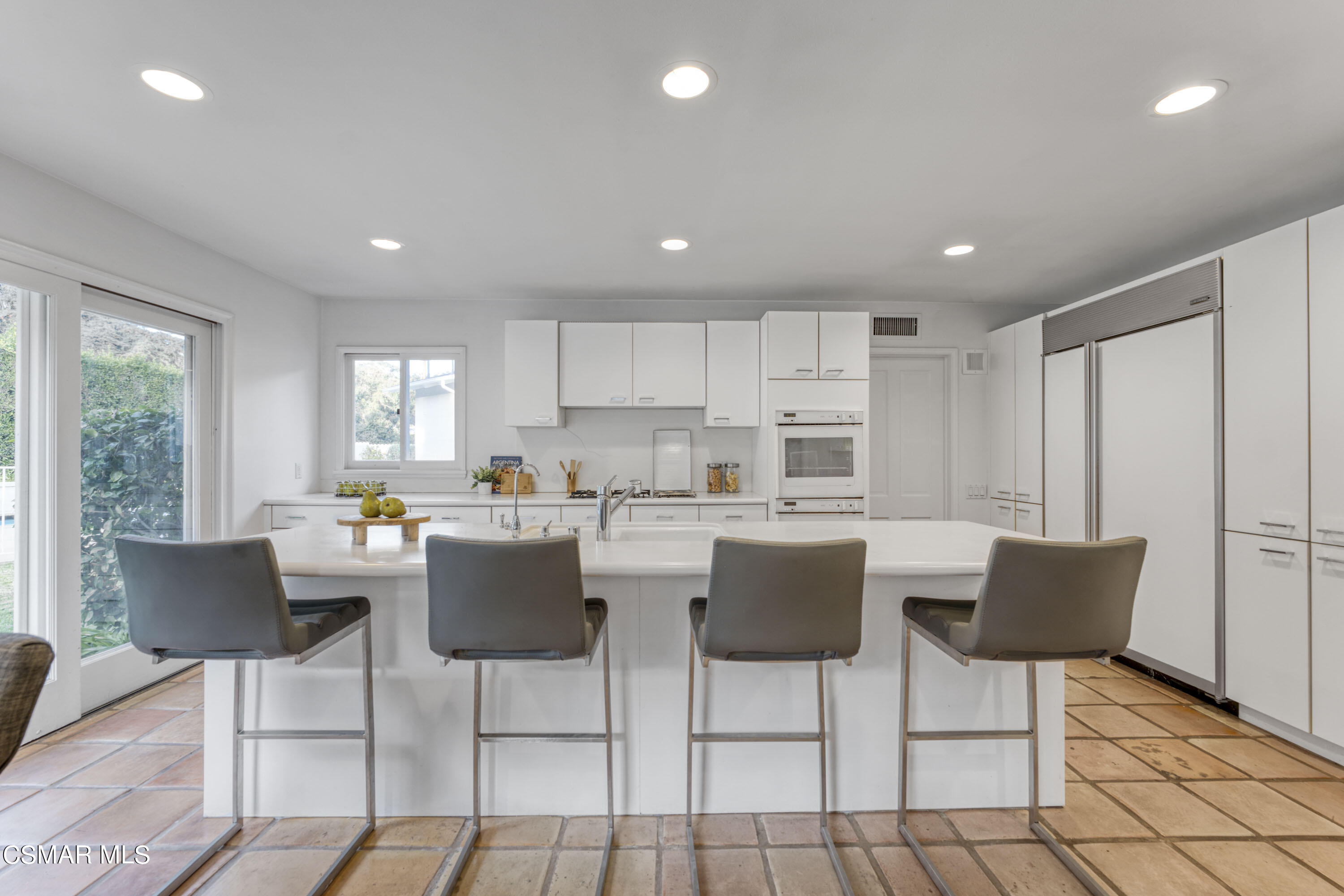 14401 Villa Woods Place Pacific Palisades, CA 90272 - Photo 9 of 46 a view of kitchen with dining table and chairs