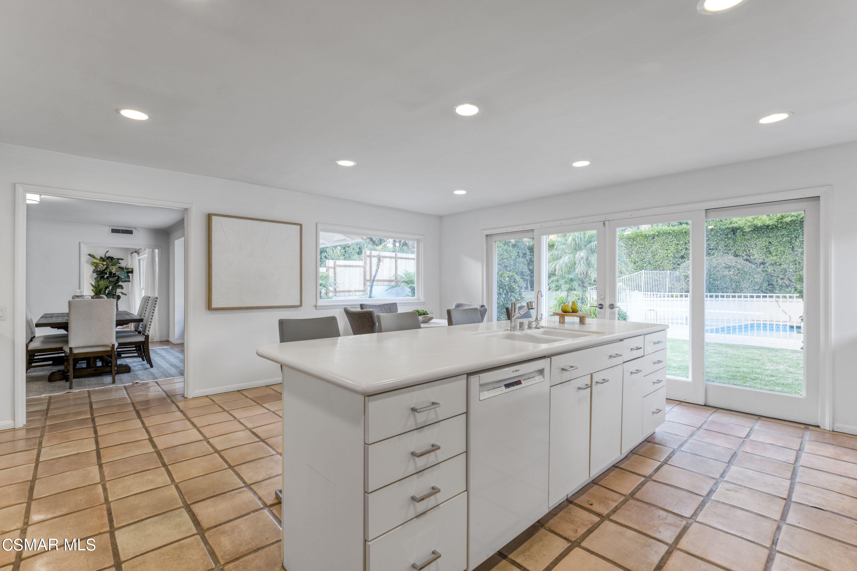 14401 Villa Woods Place Pacific Palisades, CA 90272 - Photo 10 of 46 a large white kitchen with a sink and cabinets