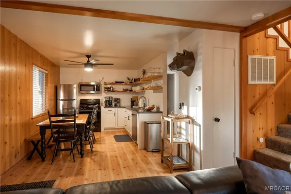 a living room with lots of furniture and a chandelier