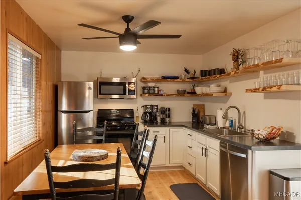 a kitchen with stainless steel appliances granite countertop a sink and cabinets
