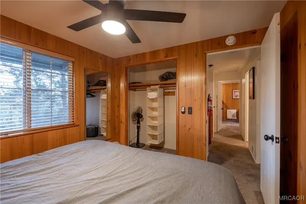 a bedroom with a bed and a large window