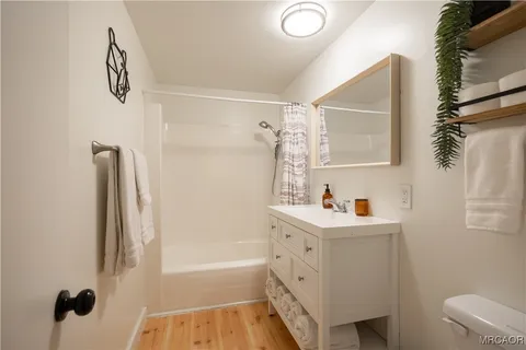 a bathroom with a bathtub a sink and a mirror