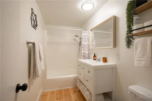 a bathroom with a bathtub a sink and a mirror