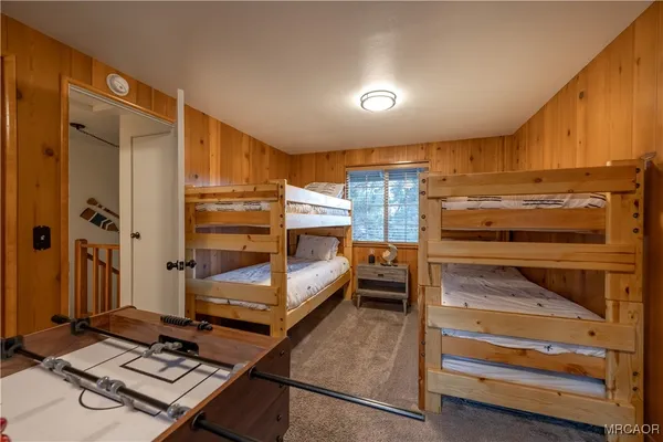 a bedroom with a bunk bed and a window
