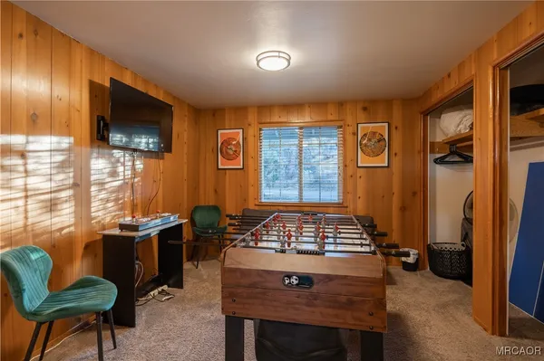 a view of a livingroom with workspace and a window