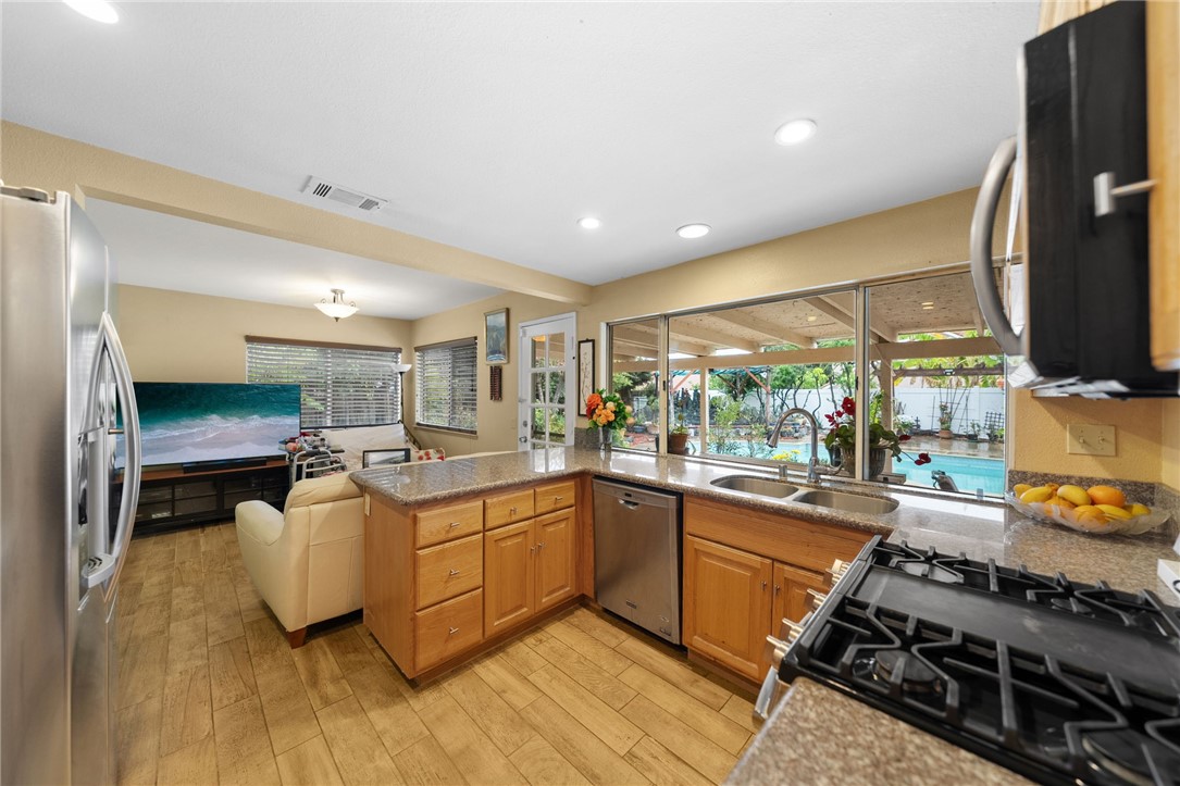 19320 Totem Court Riverside, CA 92508 - Photo 13 of 53 Open kitchen overlooks an adjacent living area with direct access to the patio and backyard, enhancing everyday functionality.