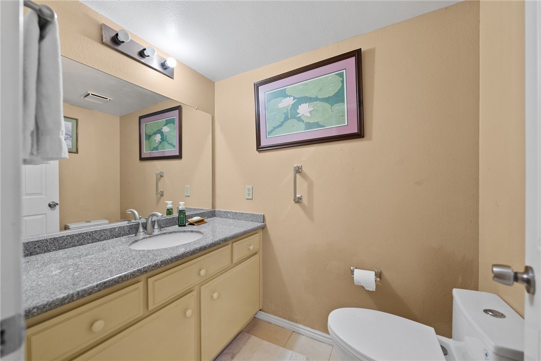 19320 Totem Court Riverside, CA 92508 - Photo 21 of 53 Clean bath with a wide vanity, granite-style countertop, and ample mirror space.