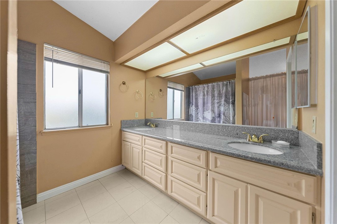 19320 Totem Court Riverside, CA 92508 - Photo 26 of 53 Spacious bath with long dual-sink vanity, ample cabinetry, and oversized mirror with bright overhead lighting.