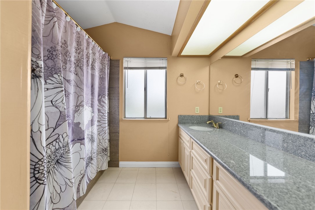 19320 Totem Court Riverside, CA 92508 - Photo 27 of 53 Another angle showcasing the dual vanity, natural light from the window, and expansive counter space.