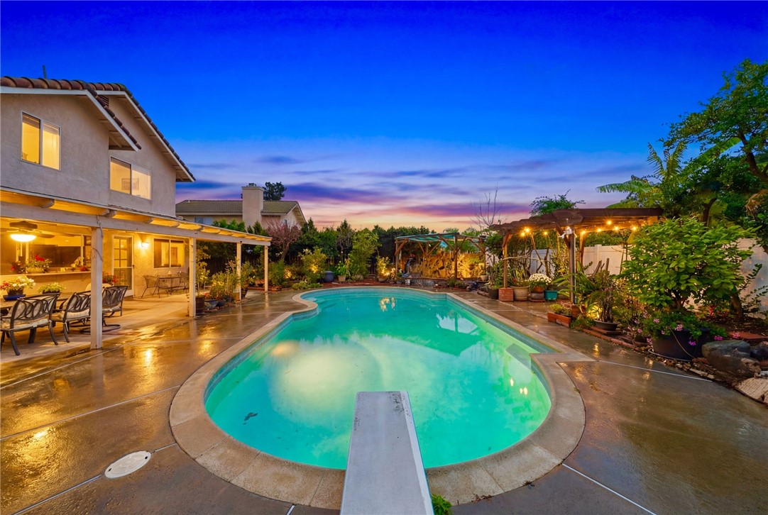 19320 Totem Court Riverside, CA 92508 - Photo 40 of 53 Resort-style backyard with a freeform pool, expansive deck space, and a covered patio—ideal for outdoor dining and entertaining.