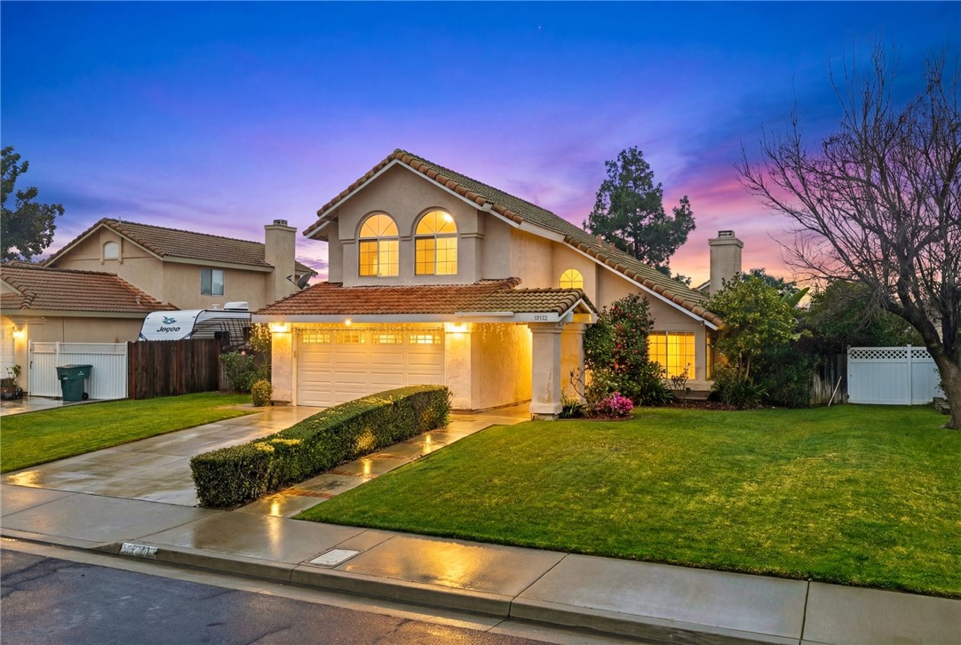 19320 Totem Court Riverside, CA 92508 - Photo 4 of 53 Twilight curb view featuring a well-kept lawn, tile roof, and illuminated windows for a warm evening presence.