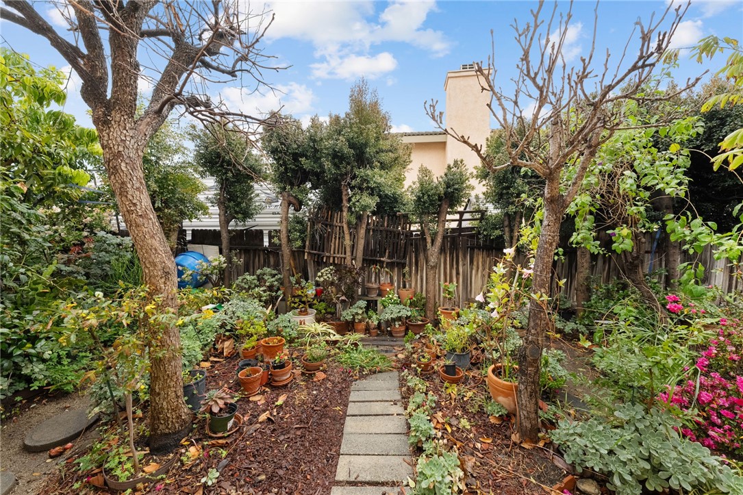 19320 Totem Court Riverside, CA 92508 - Photo 48 of 53 Cozy garden corner with stepping-stone path and abundant container plantings—ideal for a potting/gardening area.