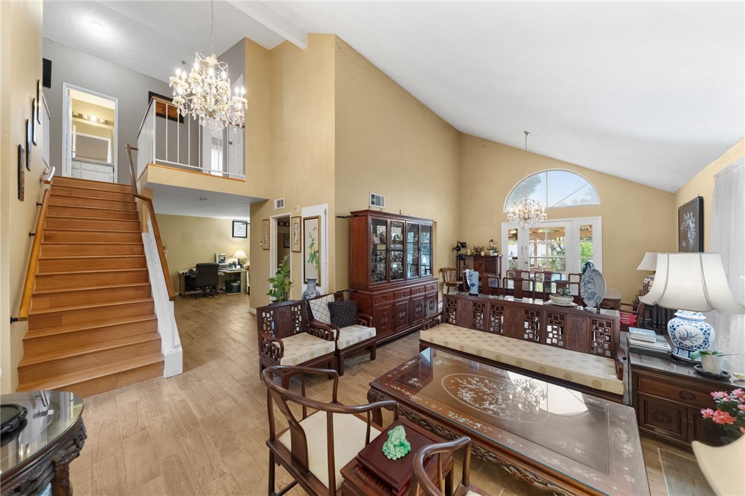 19320 Totem Court Riverside, CA 92508 - Photo 9 of 53 Open layout connecting living and dining areas with high ceilings, wide-plank style flooring, and bright windows throughout.