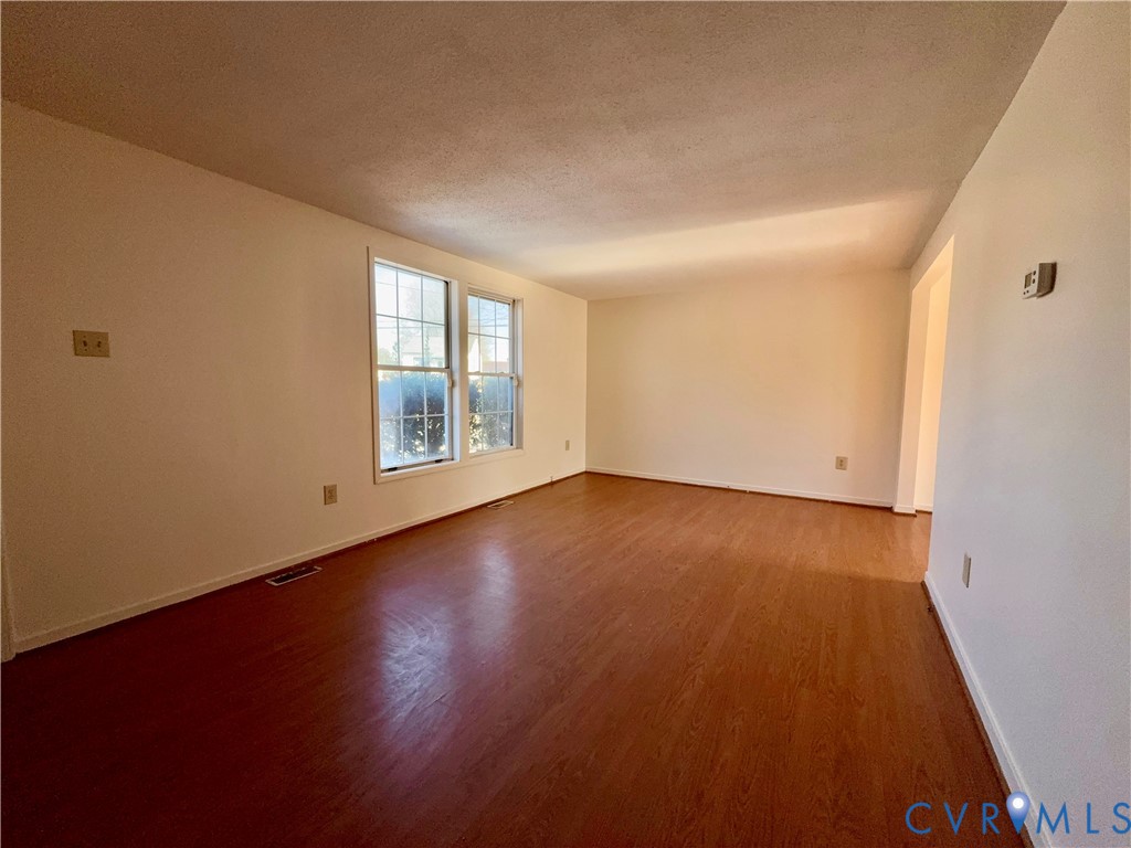 3901 Old Warwick Road Richmond, VA 23234 - Photo 12 of 21 Empty room featuring dark wood-style floors and a
