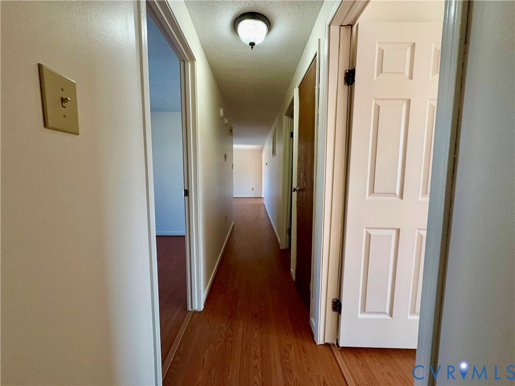 3901 Old Warwick Road Richmond, VA 23234 - Photo 15 of 21 Corridor featuring a textured ceiling and light wo
