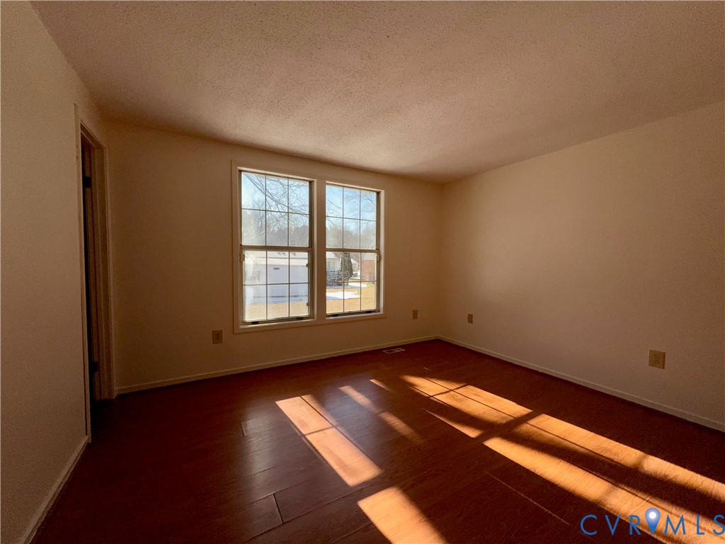 3901 Old Warwick Road Richmond, VA 23234 - Photo 19 of 21 Empty room featuring a textured ceiling and dark w