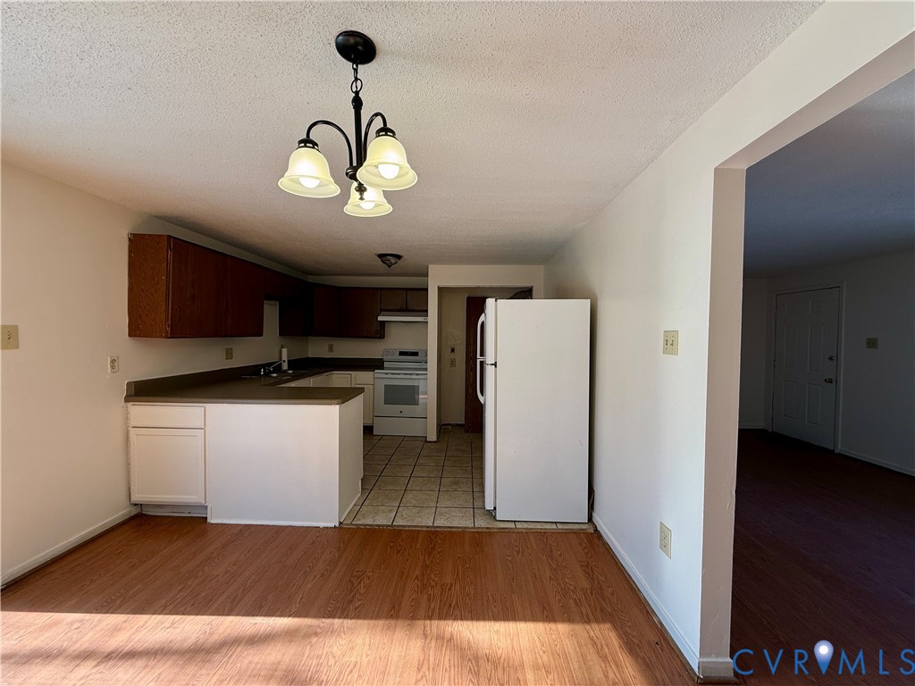 3901 Old Warwick Road Richmond, VA 23234 - Photo 6 of 21 Kitchen featuring white appliances, light wood fin