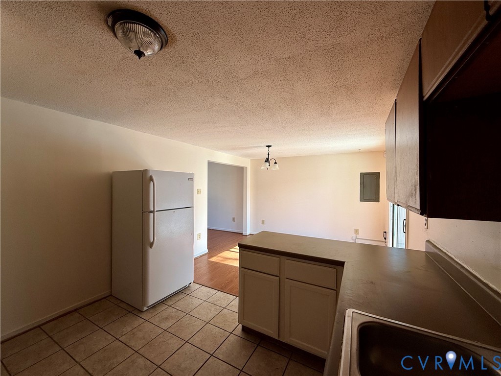3901 Old Warwick Road Richmond, VA 23234 - Photo 8 of 21 Kitchen with a peninsula, freestanding refrigerato