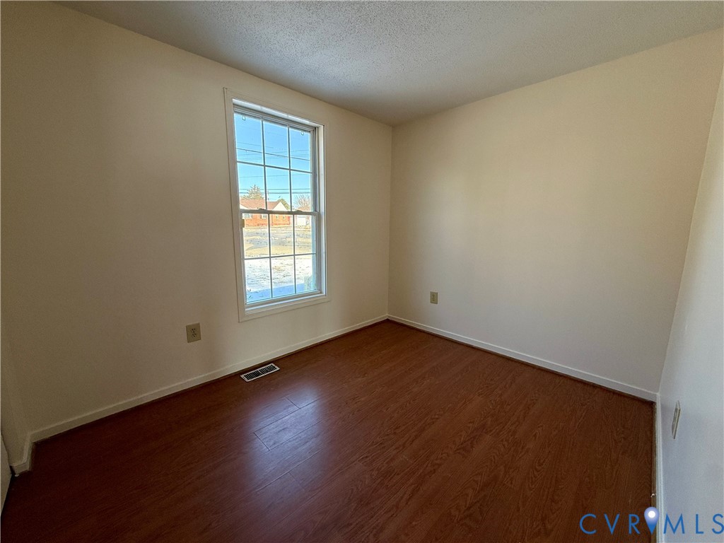 3901 Old Warwick Road Richmond, VA 23234 - Photo 9 of 21 Empty room featuring dark wood-style floors and a