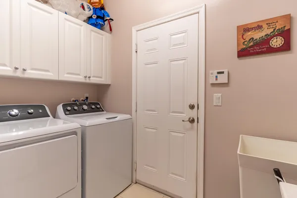 a bedroom with two beds and painting on the wall