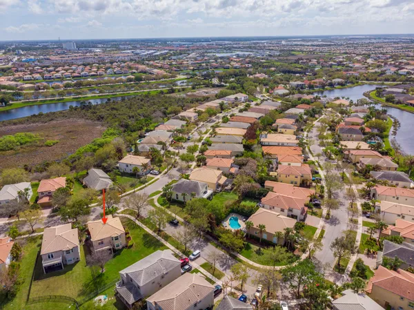 a living room with furniture kitchen view and a chandelier