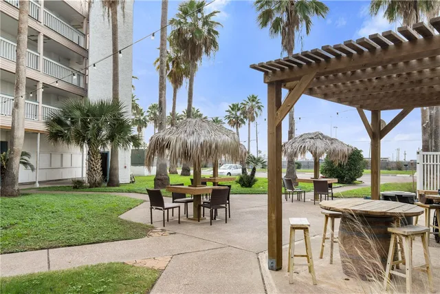a view of a dinning table and chairs in patio of a house