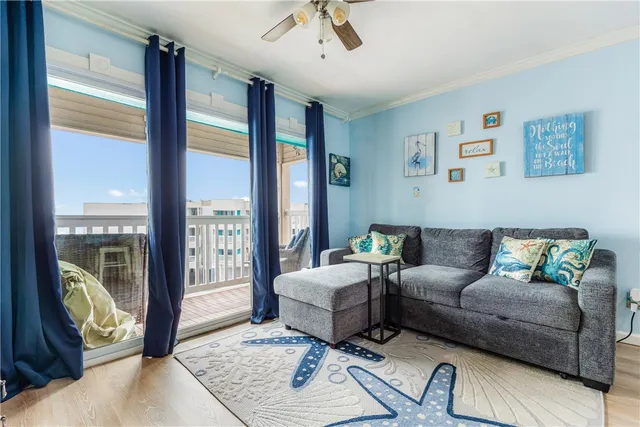 a living room with furniture and floor to ceiling windows